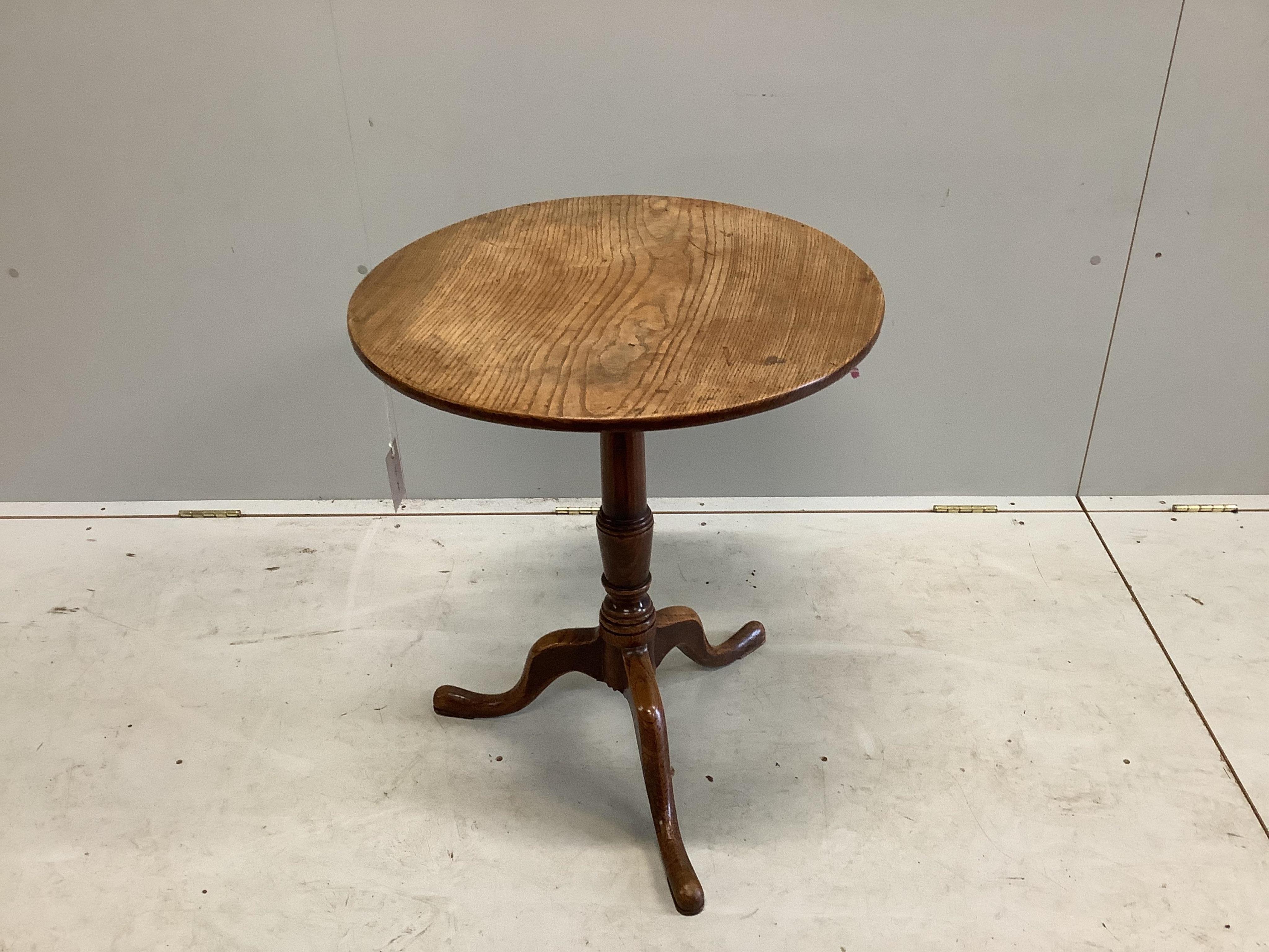 A George III circular oak tripod table, diameter 58cm, height 66cm. Condition - fair to good